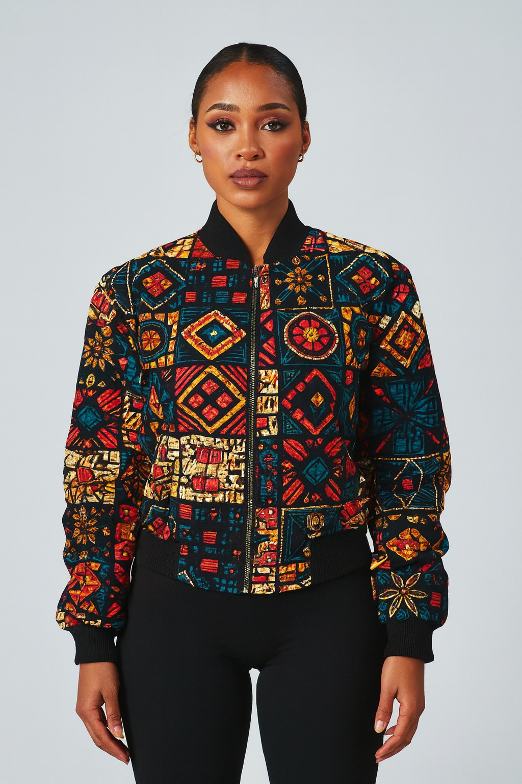 Multicolored Ankara bomber jacket with geometric African print worn by a female model.