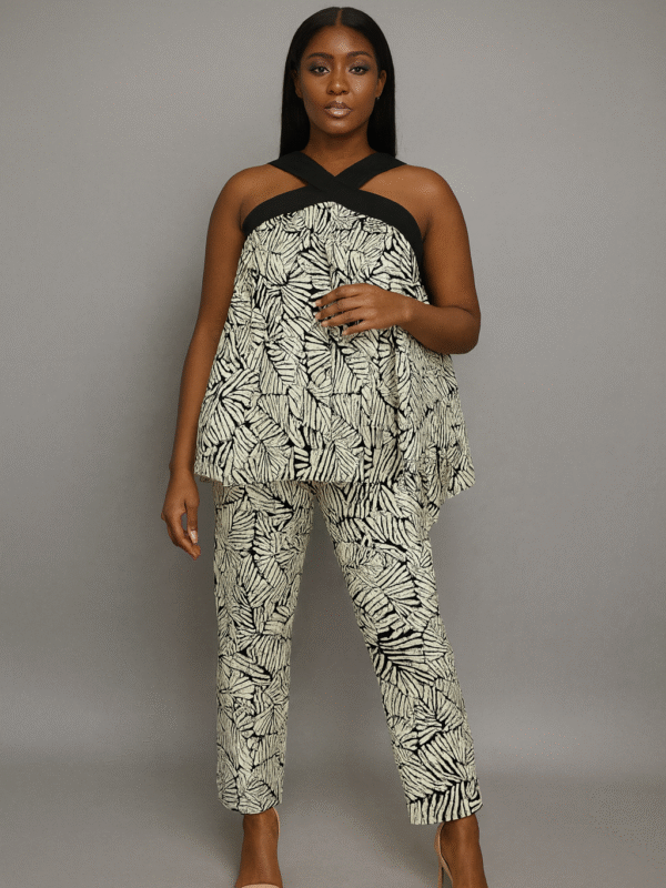Monochrome leaf-patterned two-piece set with a halter crossover top and fitted pants worn by a Black female model.